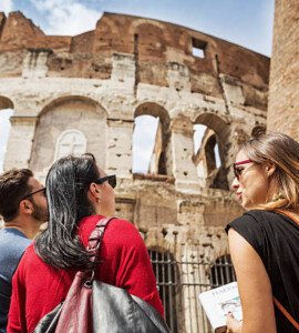 tourists with a guide in front of the coliseum, rome